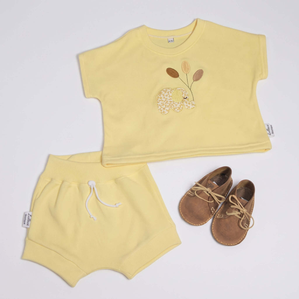 safari play cotton set for baby including yellow T-shirt, bloomer shorts, and shoes with elephant appliqué