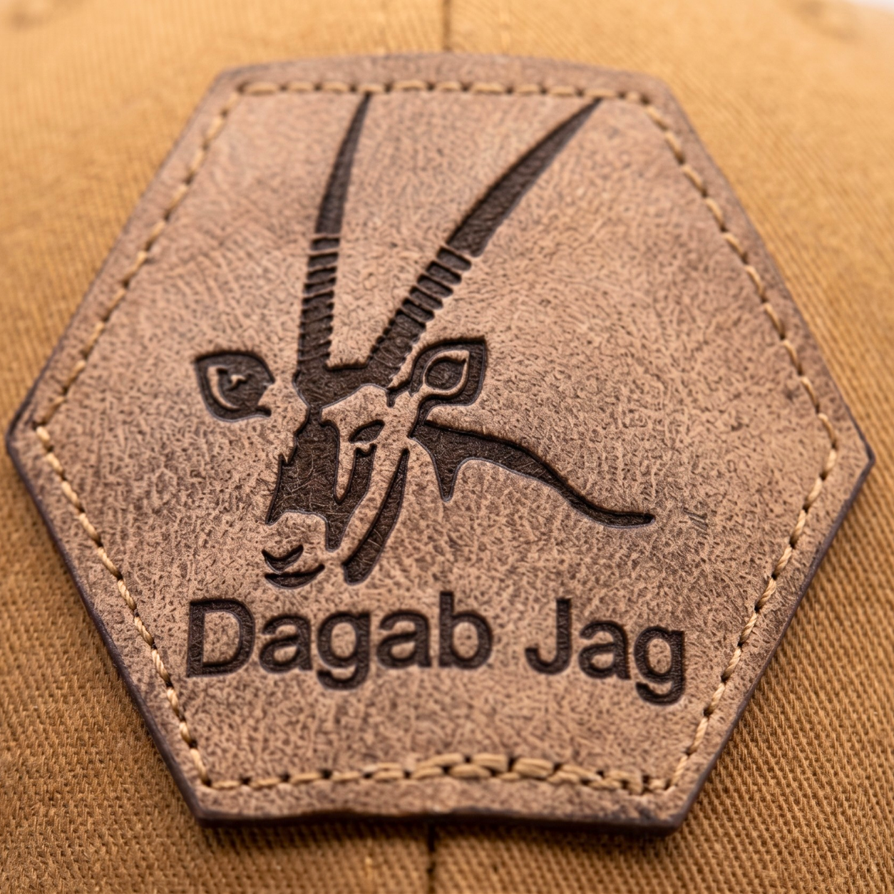 Close-up of Dagab Jag laser engraved hexagonal leather patch on trucker cap