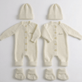 Personalised Baby Wool Knit Set featuring two cream cardigans, hats, and booties with embroidered names.