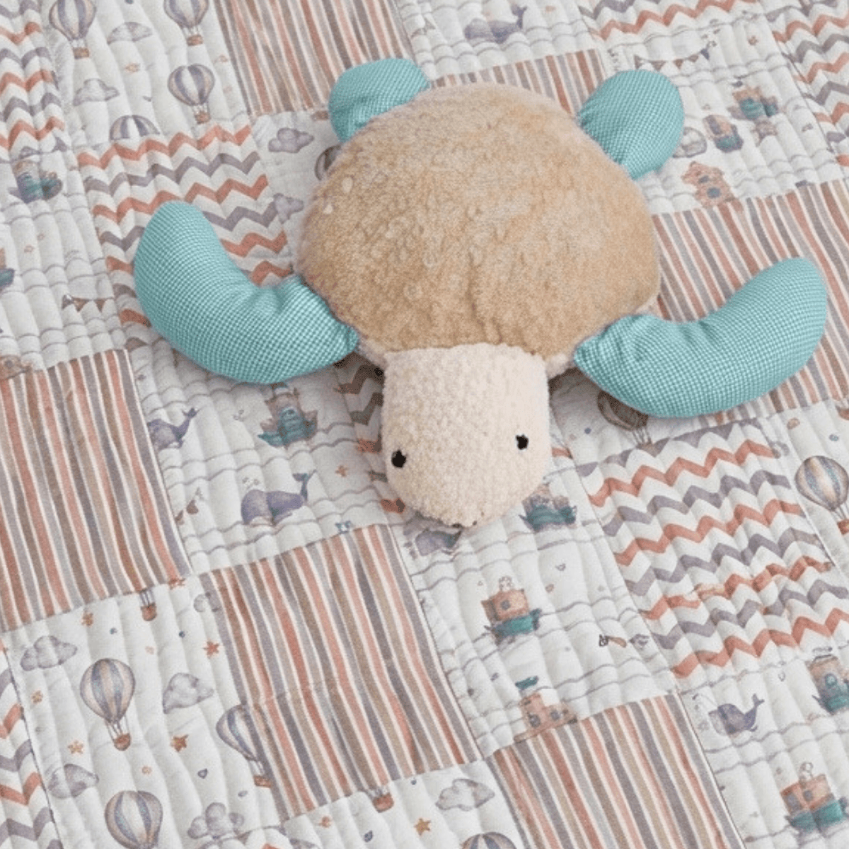 Personalised Baby-Toddler Quilt Gift Set with Pillow & Toy featuring a cute turtle plush on a patterned quilt.