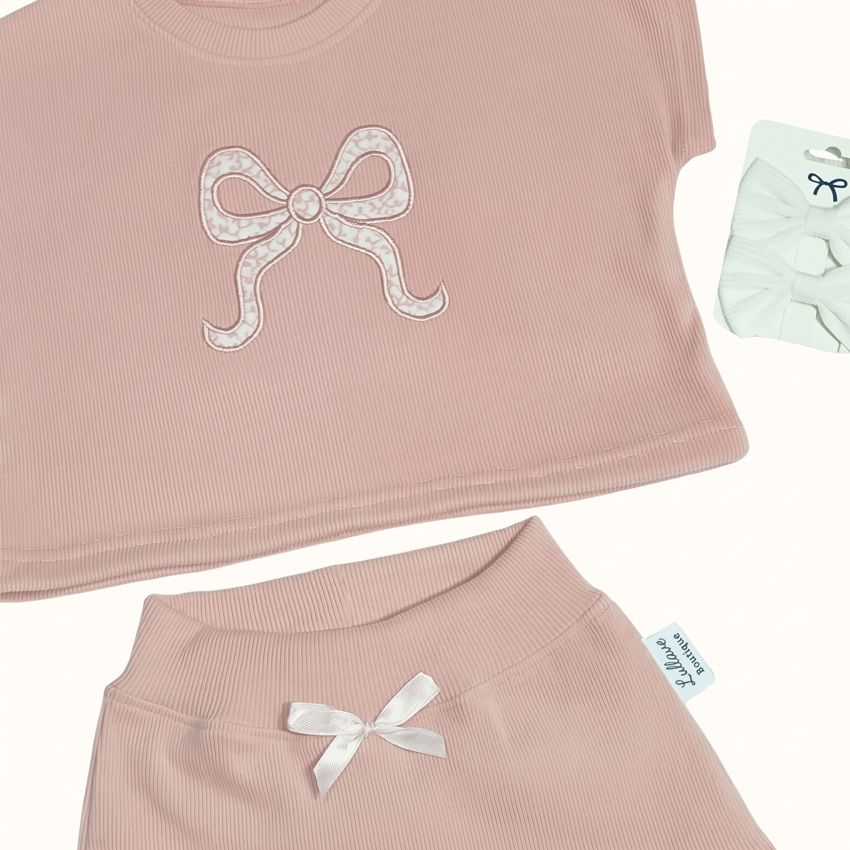 Rosewood set- cotton baby girl set featuring a blush pink top with a bow design and matching skirt.