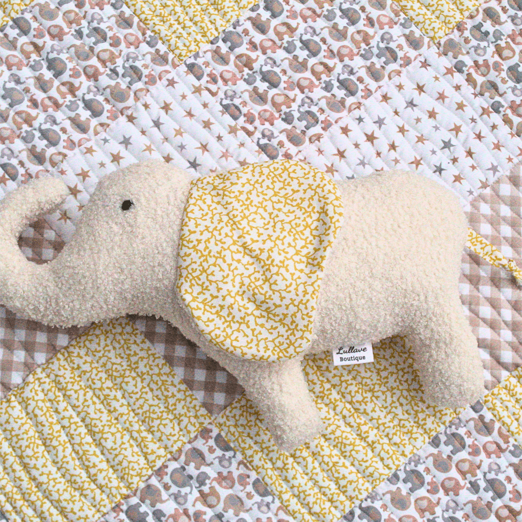 personalised handmade Little Elly baby quilt set with a soft elephant plush toy on a colorful quilt background.