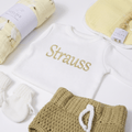 Little Goose baby Newborn Gift Box Custom Name with white knit sweater and accessories.