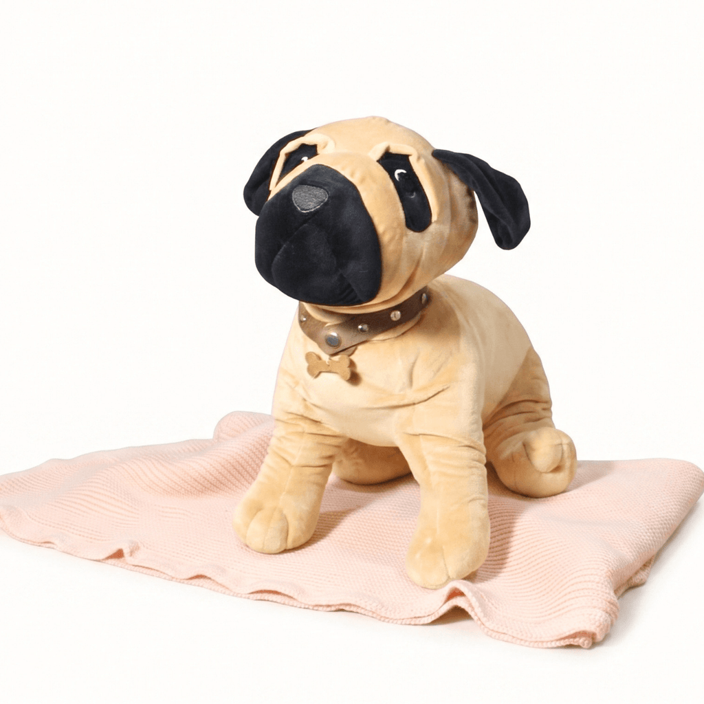 Ruffus with Personalised Baby Name plush dog toy sitting on a soft blanket with a leather collar.