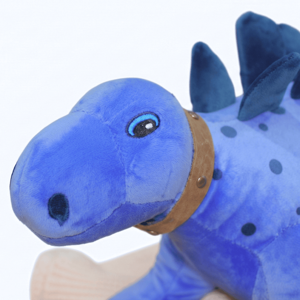 Cute close-up of Lexi Personalised Baby Name Dinosaur, the royal blue plush toy with a friendly expression.