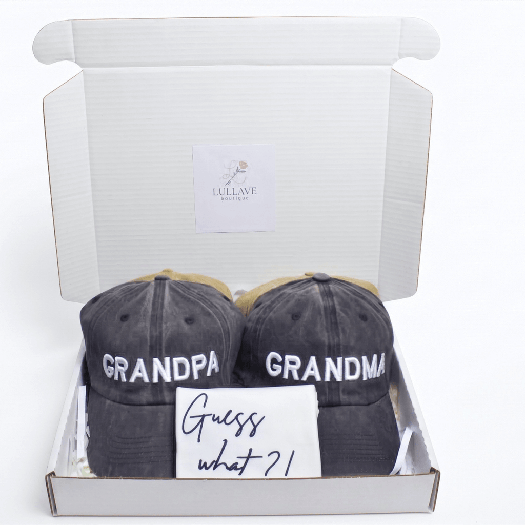 Guess What New Parents Announcement Cap Gift Box with grandparent hats and a note.